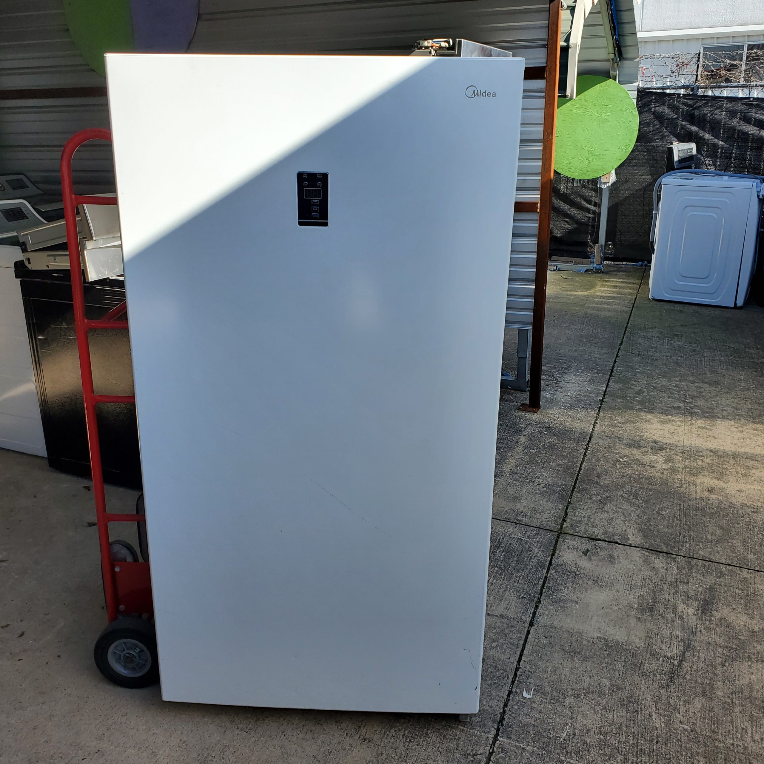picture of A salvage Midea stand up freezer that recently sold in a truckload of salvage appliances.
