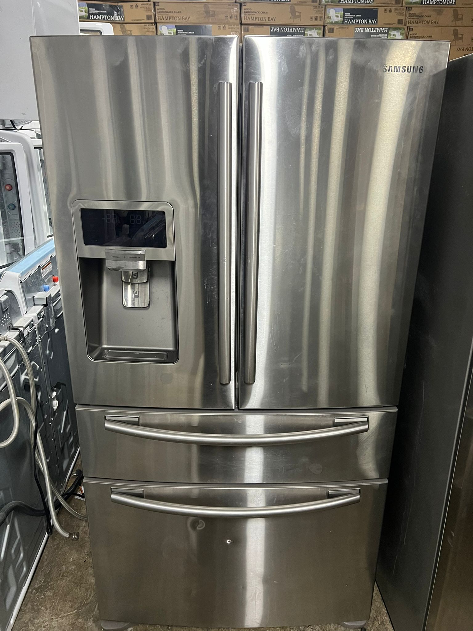 A sleek stainless steel full-size refrigerator in a kitchen setting
